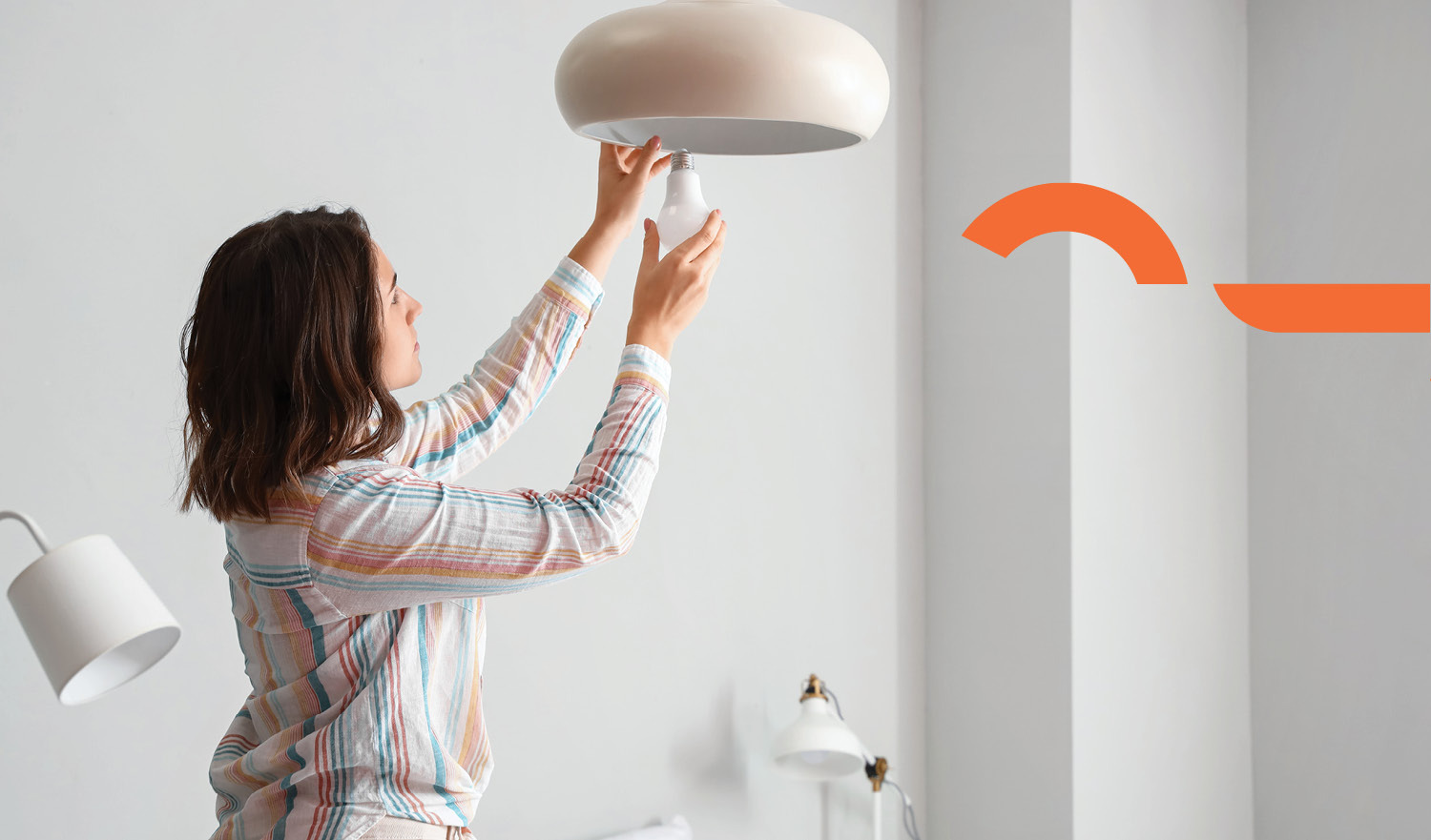 Woman changing light bulbs