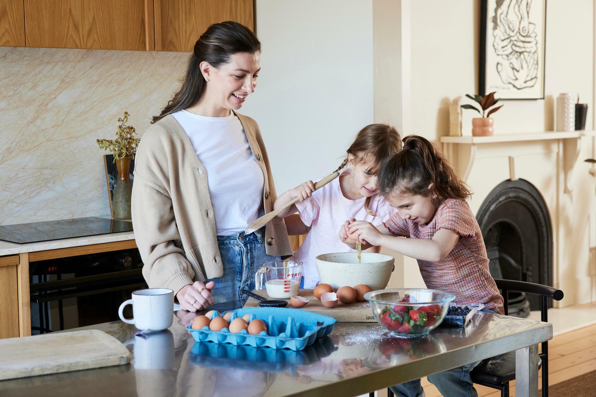 Woman and children baking in kitchen